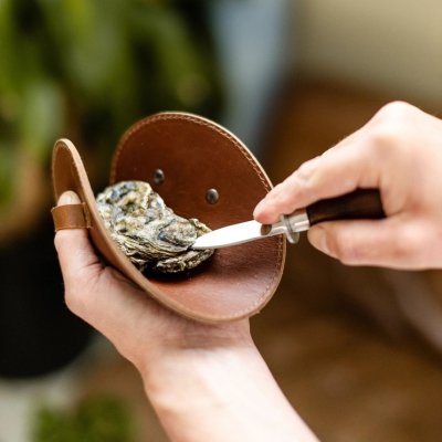 Zoom bild av ostronset handske ostronkniv presentset ostronset