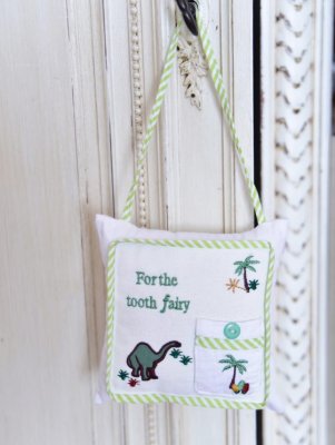 Zoom image of Dinosaur tooth fairy cushion